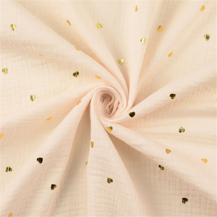 Tissu double gaze de coton beige "coeurs dorés" - Par 50cm Tissu double gaze de coton beige "coeurs dorés" - Par 50cm